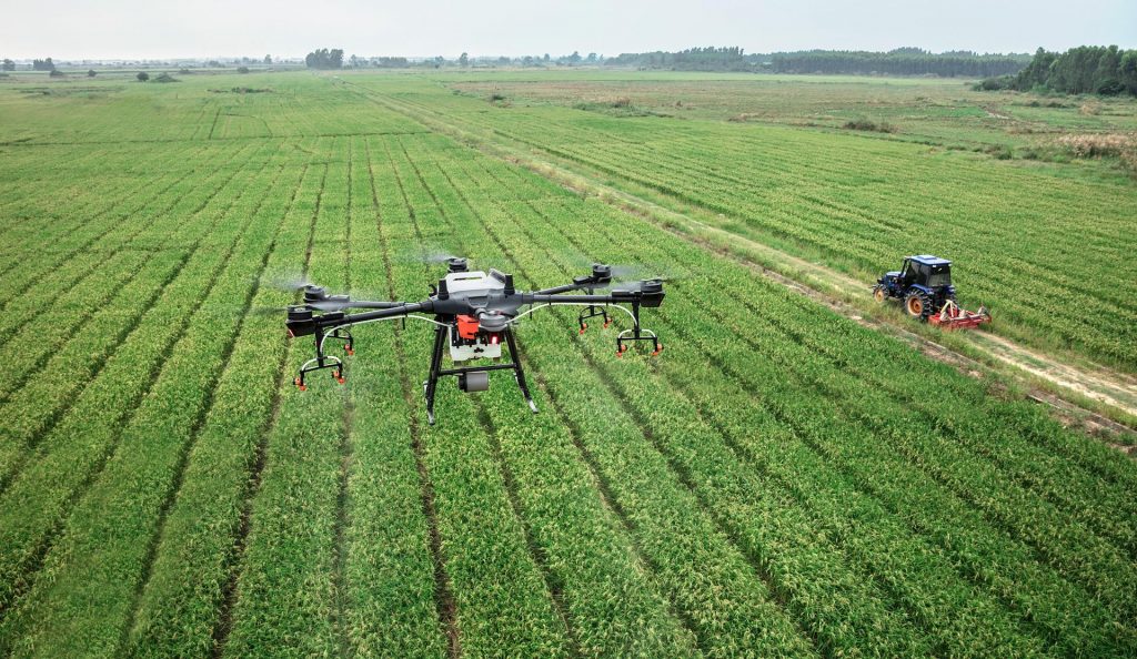 Photo about drone, fields and tractor.
